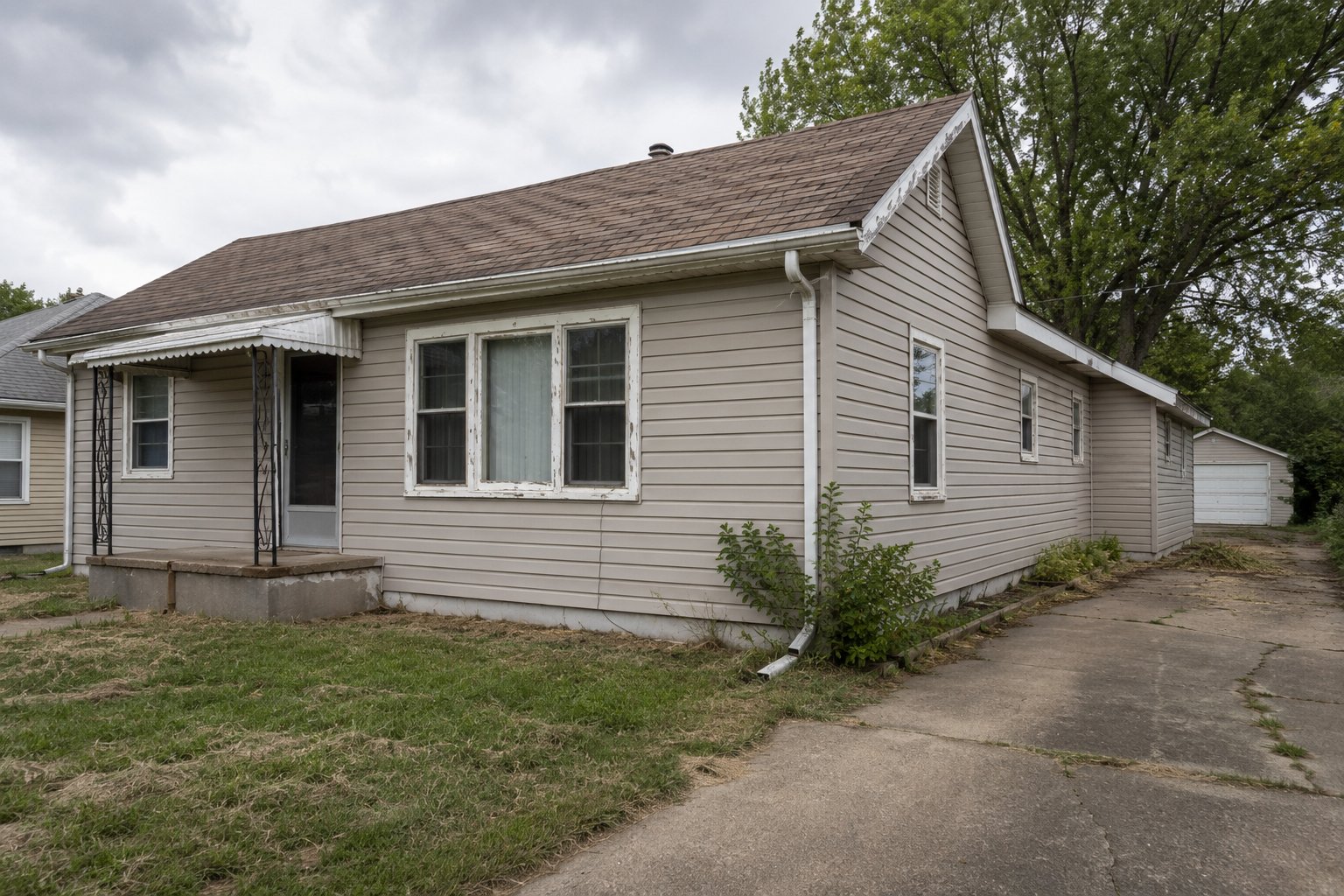 Springfield House That Needs Repairs Springfield Missouri house with worn roof shingles and deferred exterior repairs
